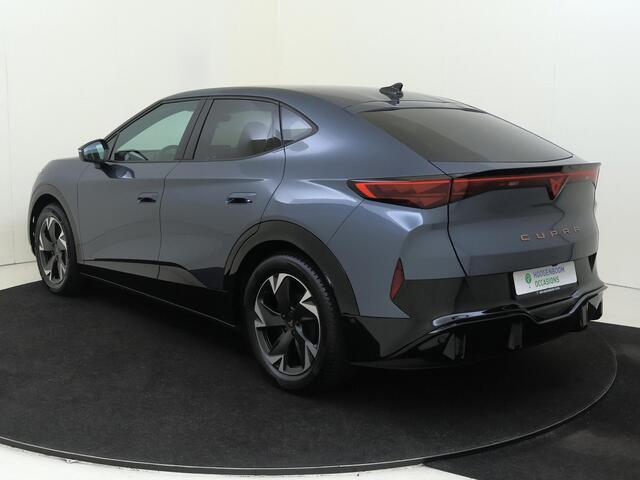 Cupra Tavascan Business 82 kWh | SoH 100% | Trekhaak | Achteruitrijcamera | 3-zone airco | Dodehoek detectie | Keyless | Adaptieve cruise control | CarPlay | Stoel- en stuurwielverwarming |