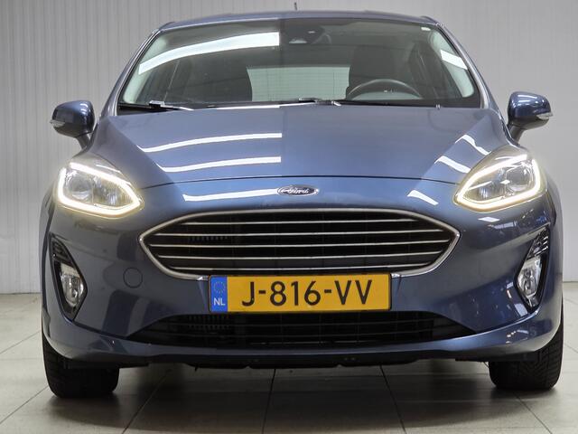 Ford FIESTA 1.0 EcoBoost Titanium/ 15'' LMV/ DAB+/ Lane-Assist./ 15'' LMV/ Clima/ Cruise/ Elek. pakket/ Isofix/ Bluetooth/ Armsteun/ Multi. LEDER. Stuur/ Mistl./ PDC/ LED Dagrijverl.
