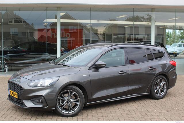 Ford FOCUS Wagon 1.0-125pk EcoBoost ST-Line AUTOMAAT ! Heel erg nette en goed onderhouden Ford Focus ST-Line wagon automaat. Volautm. airco dual, stoel-, stuur- en voorraamverw., camera, trekhaak, navigatie, telefoonvoorb., LM wln, cruise cntrl, skiluik etc., etc...