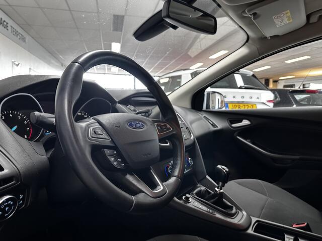 Ford FOCUS 1.0 Titanium/ Trekhaak/ 16'' LMV/ Camera/ Extra getint glas/ Apple + Android/ Navi/ Clima/ Cruise/ Elek. pakket/ Bluetooth/ Armsteun/ Multi. LEDER. Stuur/ Mistl./ PDC V+A.