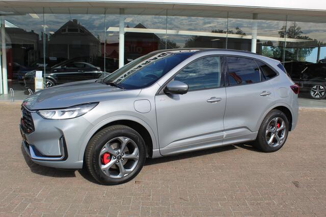 Ford KUGA 2.5-243pk PHEV ST-Line X , Trekgewicht 2100kg Febr. 2026, slechts 12.000km ! Autm. airco dual, elektr. panodak, elektr. trekhaak, elektr. achterklep, leer/alcantara, klep, LED verl., navigatie, telefoonvoorb., stoel-, stuur-, voorraam- en achterbankverw., side- en lan