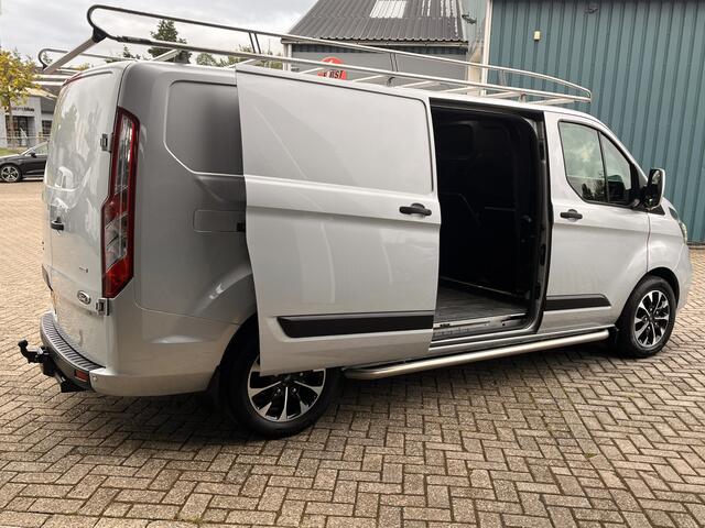 Ford TRANSIT CUSTOM 300 2.0 131Pk TDCI L2H1 Trend / Cruise / Airco / Navi / IMPERIAAL / Trekhaak / Lease ¤393,-pm / Apk t/m 25-04-2025