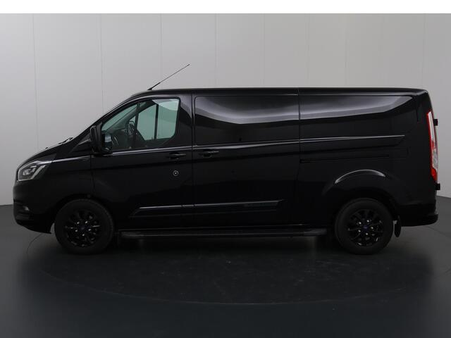 Ford TRANSIT CUSTOM 320 2.0 TDCI | Aut. | L2 H1 | Platinum | DC | Lederen bekleding | 5-zits | Navigatie | Stoelverwarming | Parkeercamera | LM Velgen | Treeplanken |