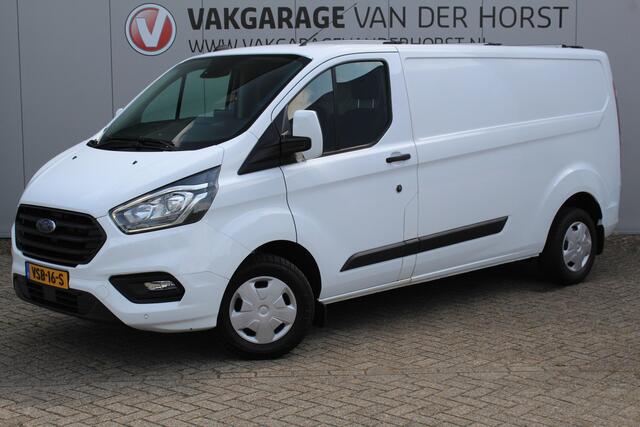 Ford TRANSIT CUSTOM 300 2.0-108pk TDCI L2H1 Trend. Erg nette Ford Transit Custom, die u nog jaren van dienst kan zijn ! Airco, voorraamverw., trekhaak, cruise control, camera, parkeersensoren v+a, 3-zits, laadruimte betimmerd etc.