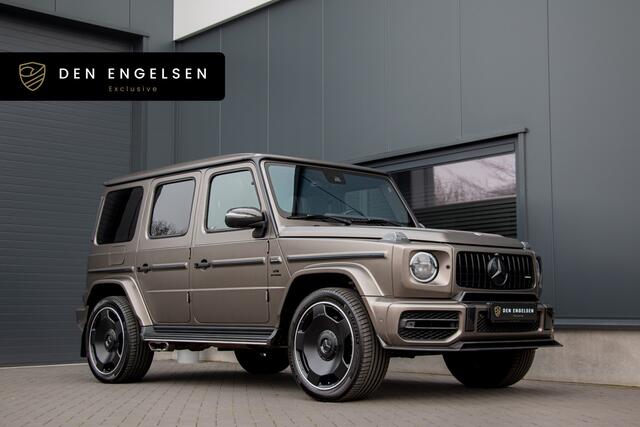Mercedes-Benz G-KLASSE - 63 AMG 585PK | Burmester 3D | Massage + Ventilatie | Akrapovic | 360 Camera | Carbon | IWC | Lane & Side Assist | MBUX | TH 3500kg | 22"| Manufaktur | Ambiance | Garageopener | N.P ¤275.681,-
