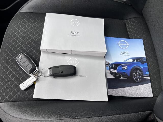 Nissan JUKE 1.0 DIG-T N-Connecta DCT Automaat / Cold pack / Allseason banden / Apple Carplay Android Auto / 17" LM wielen / Achteruitrijcamera / Stuur-, Stoel en voorruitverwarming / Navigatie / Climate control /