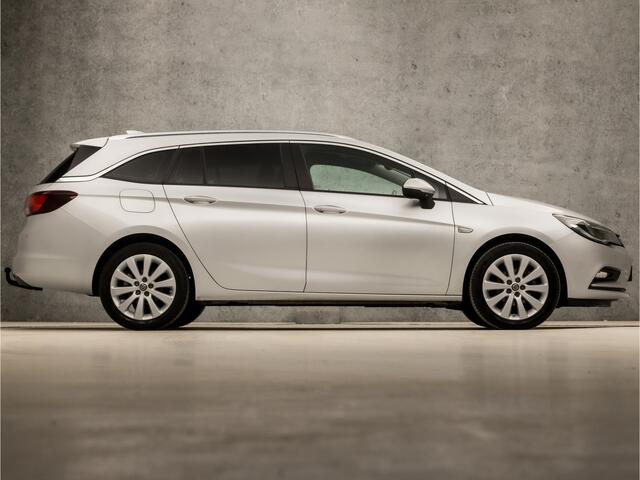 Opel ASTRA Sports Tourer 1.0 Sport (APPLE CARPLAY, GROOT NAVI, GETINT GLAS, TREKHAAK, PARKEERSENSOREN, SPORTSTOELEN, CRUISE, LM VELGEN, NIEUWE APK, NIEUWSTAAT)
