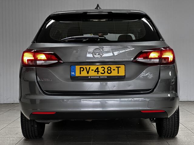 Opel ASTRA Sports Tourer 1.0 Online Edition/ PDC V+A/ Apple + Android/ DAB+/ Navi/ Airco/ Cruise/ Elek. pakket/ Isofix/ Bluetooth/ Armsteun/ Multi. LEDER. Stuur/ LED Dagrijverl.