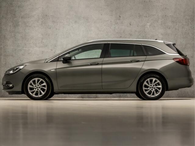 Opel ASTRA Sports Tourer 1.2 Elegance 146Pk (APPLE CARPLAY, GROOT NAVI, CLIMATE, CAMERA, LEDER, GETINT GLAS, SPORTSTOELEN, KEYLESS, LANE ASSIST, LED KOPLAMPEN, DAB+, LM VELGEN, NIEUWSTAAT)