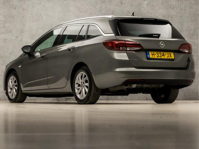 Opel ASTRA Sports Tourer 1.2 Elegance 146Pk (APPLE CARPLAY, GROOT NAVI, CLIMATE, CAMERA, LEDER, GETINT GLAS, SPORTSTOELEN, KEYLESS, LANE ASSIST, LED KOPLAMPEN, DAB+, LM VELGEN, NIEUWSTAAT)