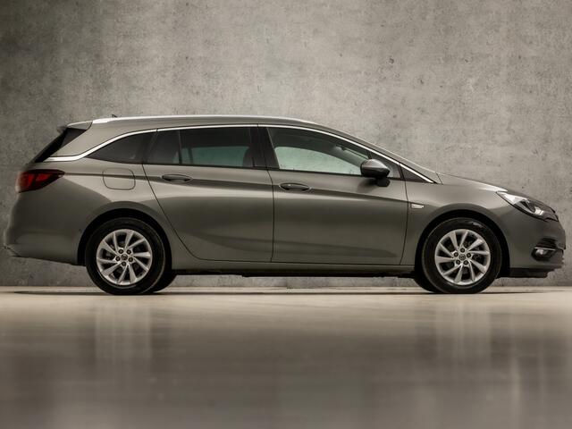 Opel ASTRA Sports Tourer 1.2 Elegance 146Pk (APPLE CARPLAY, GROOT NAVI, CLIMATE, CAMERA, LEDER, GETINT GLAS, SPORTSTOELEN, KEYLESS, LANE ASSIST, LED KOPLAMPEN, DAB+, LM VELGEN, NIEUWSTAAT)