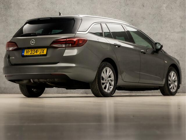 Opel ASTRA Sports Tourer 1.2 Elegance 146Pk (APPLE CARPLAY, GROOT NAVI, CLIMATE, CAMERA, LEDER, GETINT GLAS, SPORTSTOELEN, KEYLESS, LANE ASSIST, LED KOPLAMPEN, DAB+, LM VELGEN, NIEUWSTAAT)