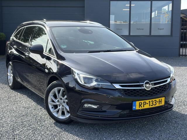 Opel ASTRA Sports Tourer 1.4 Business Executive ?2 Eigenaar?Camera?Navi?Trekhaakt?Carplay?Stoelverw?Stuurverw?Automaat?Dealer Onderhouden?Keyless?Clima?Cruise?Pdc V+A?Halfleder?Comfortstoelen?150pk?Rijstrooksensor?Dodehoeksensor?Elekt Stoelen?Lm velgen?N.A.P?Apk tot 03-2027