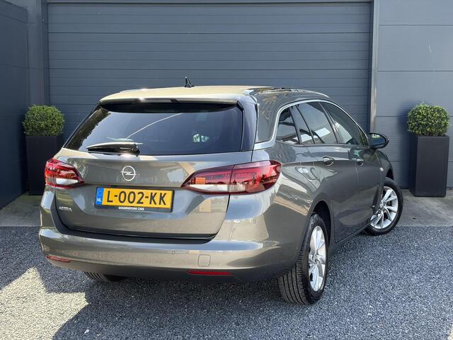 Opel ASTRA Sports Tourer 1.2 Business Elegance ?1e Eigenaar?110pk?Carplay?Camera?Navi?Clima?Cruise?Halfleder?Comfortstoel?Pdc V+A?6 Bak?Dealer Onderhouden?Keyless?Lm velgen?N.A.P?Apk tot 06-2027