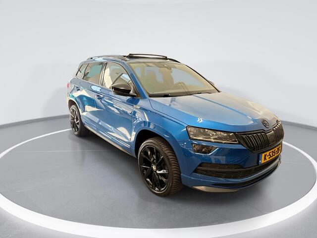 Skoda Karoq 1.5 TSI 150pk DSG Sportline Business · Panoramadak · Camera · Stuur- & Stoelverwarming · Trekhaak · Canton Audio · Dodehoeksensor · Keyless ·