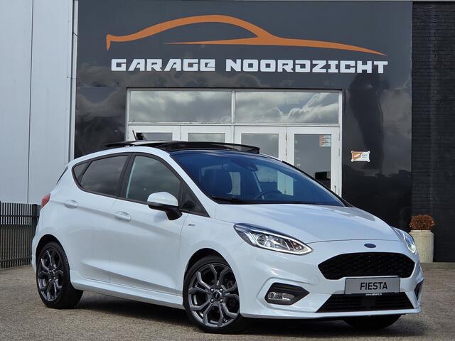 Ford FIESTA 1.0 ST-Line PANORAMADAK|NAVIGATIE|CAMERA|CRUISE CONTROL|STOEL&STUUR VERWARMING|ECC/AIRCO|PDC ACHTER|17 INCH|DEALERE ONDERHOUDEN Maandag tot Vrijdag geopend van 09.00 tot 20.00 uur en Zaterdag van 09.00 tot 18.00 uur