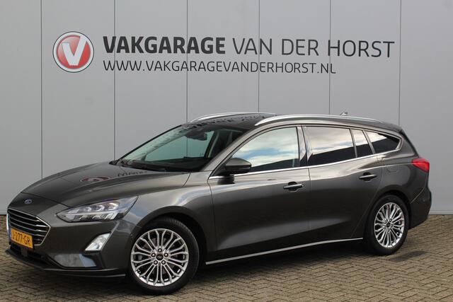 Ford FOCUS Wagon 1.0-125pk EcoBoost Titanium Business. Uiterst nette, comfortabele en ruime stationcar. Stoel-, stuur- en voorraamverw., Trekhaak, B&O soundsyst, lane assist, adaptieve cruise cntrl, camera a, LM wln, navigatie, telefoonvoorb. etc