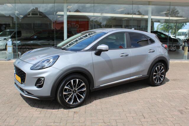 Ford PUMA 1.0-125pk EcoBoost Mild-Hybrid Titanium X. Garantie t/m 07-03-2028 ! Slechts 7.400km ! Cruise cntrl, climate cntrl, stoel-, stuur- en voorraamverw., draadloos opladen telefoon, trekhaak afneembaar, navigatie, telefoonvoorb., LM wielen, B&O soundsyst., dig