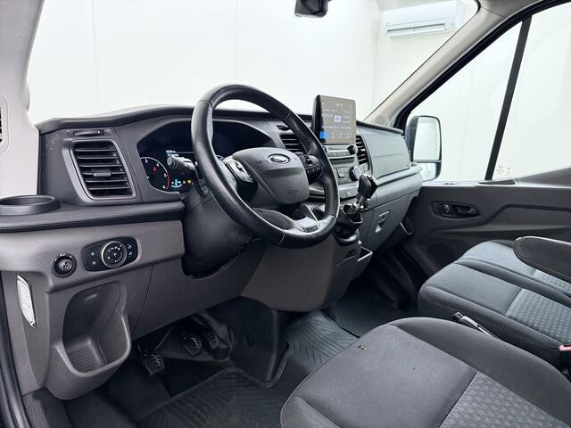 Ford TRANSIT 310 2.0 TDCI L2H2 3-Persoons Camera Airco Stoelverwarming Elek.Stoel Cruise Control Pdc Lane Assist Trend Betonplex Vloer Wandbetimmering Schuifdeur Voorruitverwarming 1e Eigenaar Origineel Nederlandse Bus